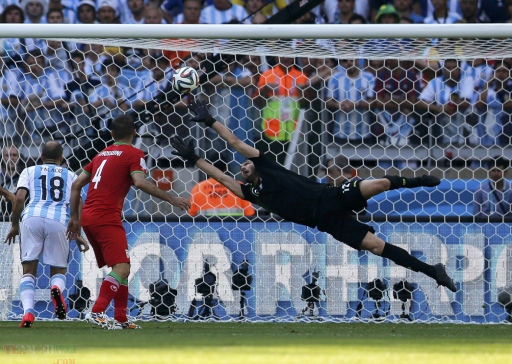 Iran's goalkeeper Haghighi fails to save a goal by Argentina's Messi during their 2014 World Cup Group F match at the Mineirao stadium in Belo Horizonte