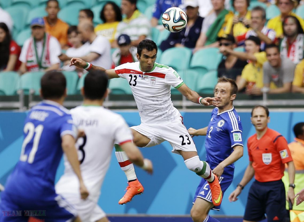 Mehrdad Pouladi heads the ball during a group F World Cup soccer match between Bosnia and Iran at the Arena Fonte Nova in Salvador